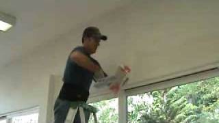 Applying a skim coat layer of drywall mud to a bullnose corner edge [upl. by Wiersma]