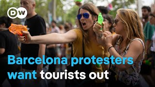 Barcelona Protesters squirt water pistols at foreigners in attempt to reclaim their city  DW News [upl. by Hbaruas937]