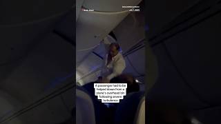 A passenger had to be helped down from a plane’s overhead bin following severe turbulence [upl. by Rasmussen]