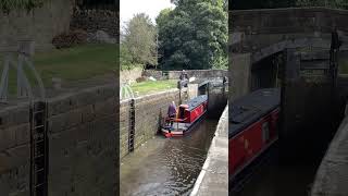 Silsden hire boat departs the locks at Gargrave heading towards Skipton on the Leeds Liverpool canal [upl. by Aicnarf]