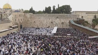 Jewish worshippers gather at Jerusalems Wailing Wall for the traditional priestly blessing prayer [upl. by Bergh]