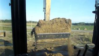 CAT 320 stripping clay and loading rock trucks cab view [upl. by Keligot]