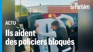 Marseille  des jeunes aident des policiers bloqués dans une voiture retournée [upl. by Yecram]