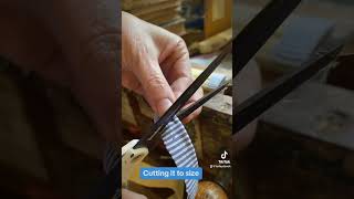 Bookbinder cuts and applies cloth headband to book bookbinding bookrepair bookbindery books [upl. by Suzy]