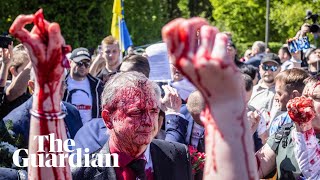 Russian ambassador doused in red by antiwar protesters in Poland [upl. by Nilyahs]