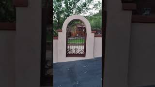 2 wrought iron gates installed in a courtyard  by Affordable Fence and Gates Tucson AZ [upl. by Annetta]