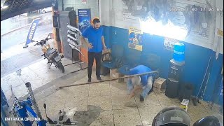 CAUGHT ON CAMERA Ouch Man hit by metal bar twice in Brazil car shop [upl. by Ahsitra]