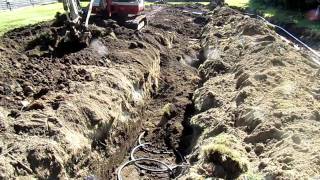 Backfilling earth loop trenches for a geothermal heat pump [upl. by Atikat]