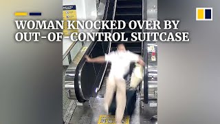 Woman knocked over by outofcontrol suitcase left on escalator [upl. by Wenn63]