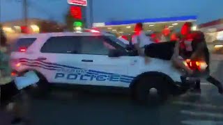 Protesters hit by police car as it drives through crowd in Detroit [upl. by Nyrehtac512]