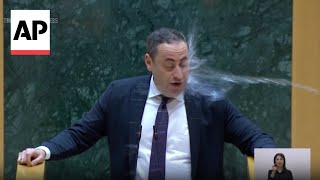 WATCH Georgian opposition lawmaker doused with water during parliament speech [upl. by Lashonde]