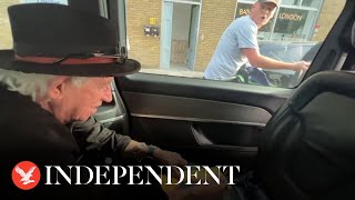 Keith Richards jokes with cyclists as he signs autograph for him in back of taxi [upl. by Anaer]