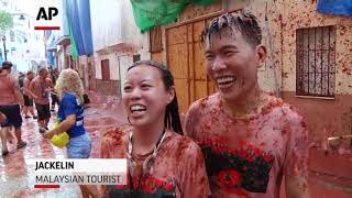 Spains Tomatina Thousands throw tomatoes [upl. by Adnuhsor]