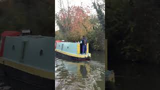 Small narrowboat cruises past Campbell Park in Milton Keynes on its way to Fenny Stratford canal [upl. by Aihselef]