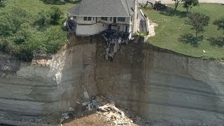 Couple looks on as house falls off cliff [upl. by Naynek456]