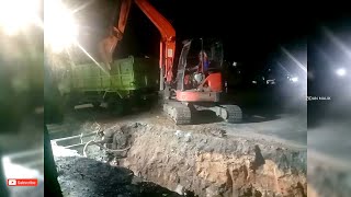 Kubota excavator works lifting the excavated soil onto the truck road water channel culvert work [upl. by Eecart]