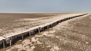 GLOBALink  Drought makes 400yearold stone bridge surface from lake in China [upl. by Ava]