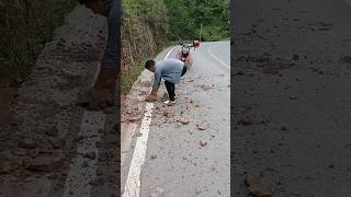 A good motorcycle man stops and clean the road from stones Heroes of humanity 🙏 viral humanity [upl. by Lotti]