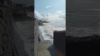 Waves crashing against the sea wall in Pendine 🌊beach wales [upl. by Ilesara]