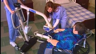 Transferring a patient from wheelchair to bed with a Reliant 600 and full body sling [upl. by Dorlisa]