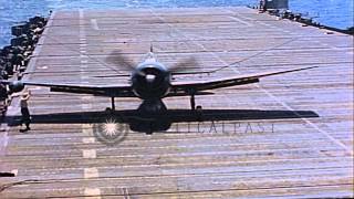 US F6F Hellcats landing on aircraft carrier in Pacific during WW II FirefighteHD Stock Footage [upl. by Kcirdneh181]