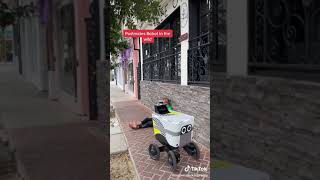 Postmates robot driving past homeless person [upl. by Aillil]