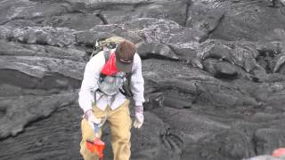 Geologist collects a fresh lava sample in Hawaii in May 2014 [upl. by Yeliac]