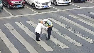 Cars waiting for the elderly to cross the street in SW China [upl. by Hawger]