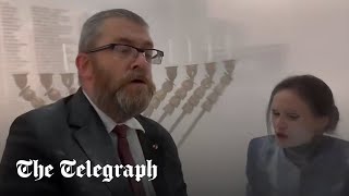 Polish MP uses fire extinguisher to snuff out Jewish menora in parliament [upl. by Pierre516]