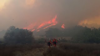 Fire crew clear out vegetation as fire burns into the evening northwest of Los Angeles [upl. by Ssegrub]