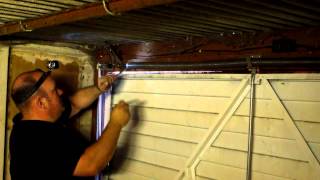 How to adjust the spring tension on a garage door in Manchester [upl. by Namhcan739]