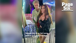 Megan Fox gets slammed into barricade as man tries to punch Machine Gun Kelly at fair [upl. by Caron]