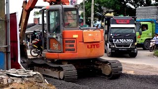 Excavator Hitachi works to level coral stone for the asphalting process in a road expansion project [upl. by Lenni454]