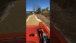 Laying down more gravel grading and compacting it with the roller kubotatractor excavation [upl. by Lseil]