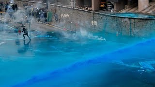 Hong Kong police spray protesters with bluedye water cannons [upl. by Armilla]