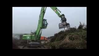 SENNEBOGEN  Recycling Material Handler 825 feeding shredder loading compost [upl. by Ysset]