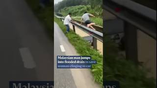 Malaysian jumps into flooded drain to save woman clinging to car [upl. by Niliram]