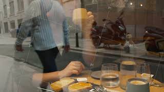 Woman eating at a table in a cafe  through the glass [upl. by Melissa190]