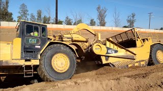 CAT 657G and 651B scrapers moving dirt  D9T Dozer ripping and pushing [upl. by Gintz114]