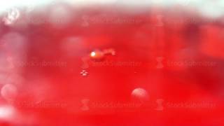 Bubbles from a fizzy drink Red liquid extra closeup Drink in glass [upl. by Yentihw]